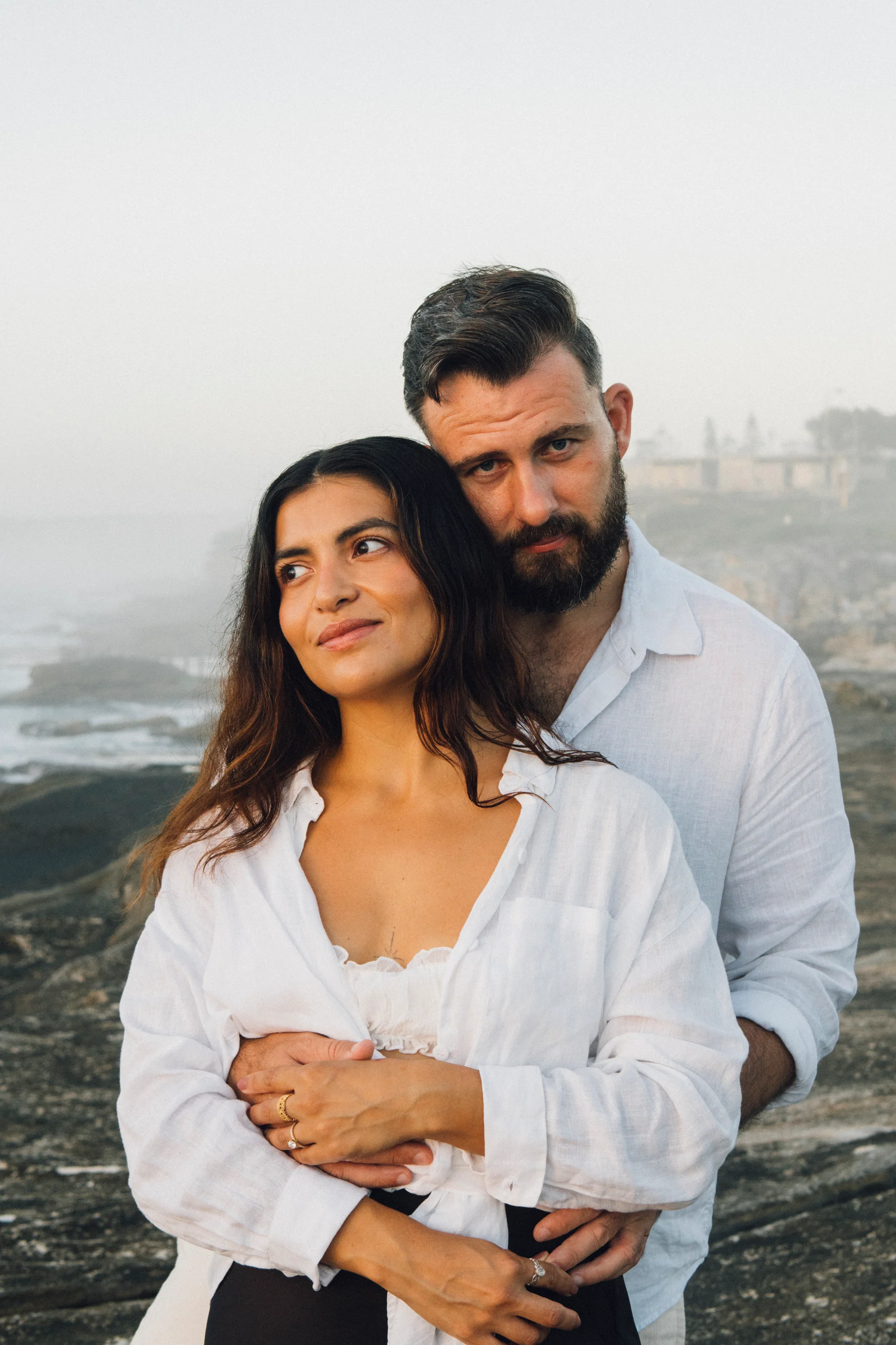 A couple holding hands at sunrise at Maroubra, Sydney