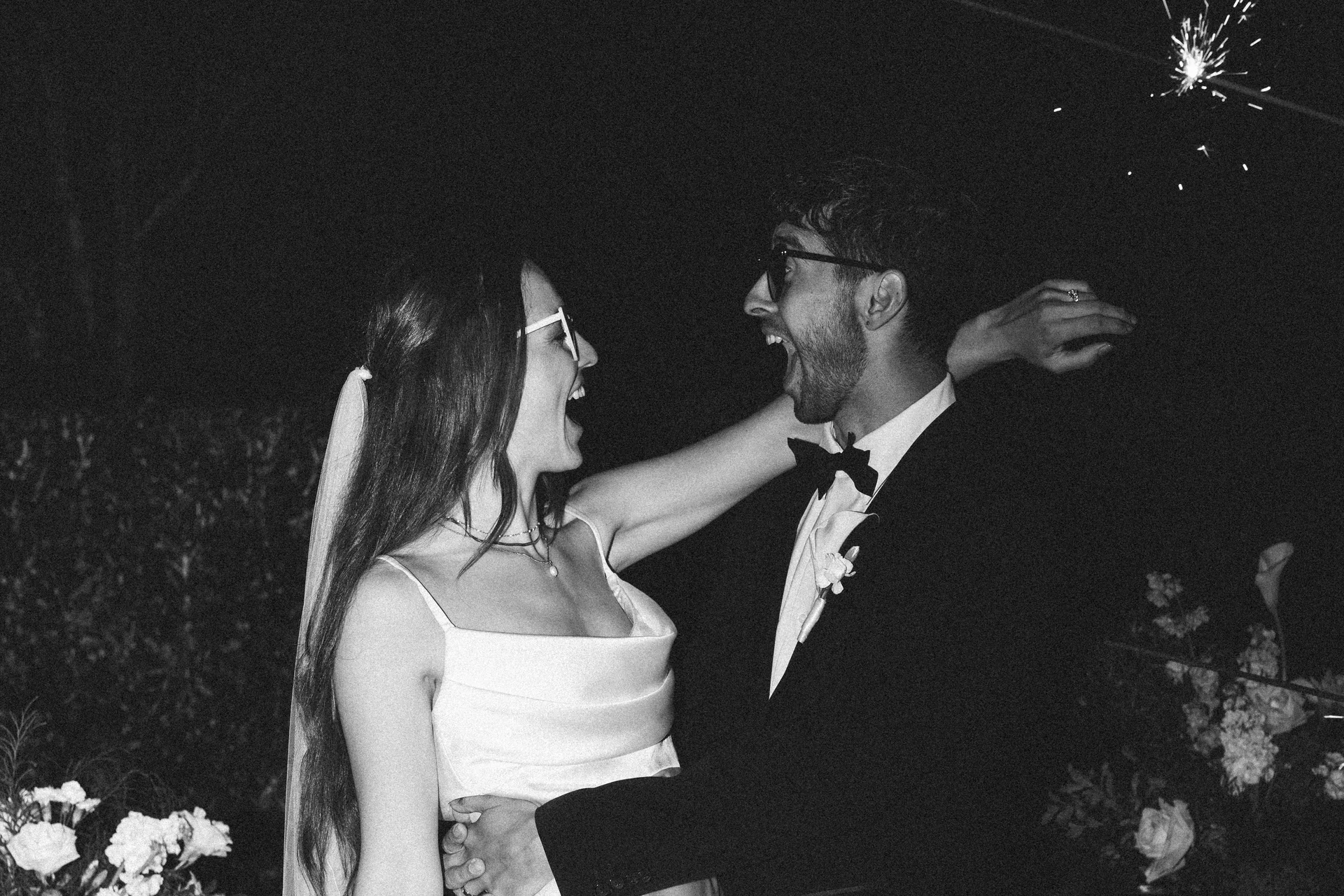 A couple laughing together under a sparkler at night, Sydney