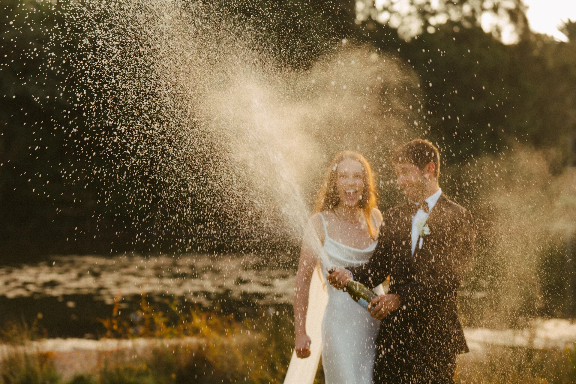 A wide, full-bleed photograph of a champagne shower from a recent wedding.